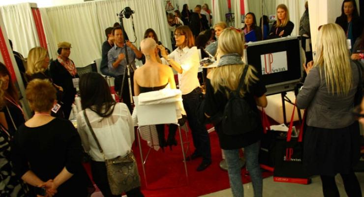 A makeup demo on the show floor at MakeUp in NewYork 2013